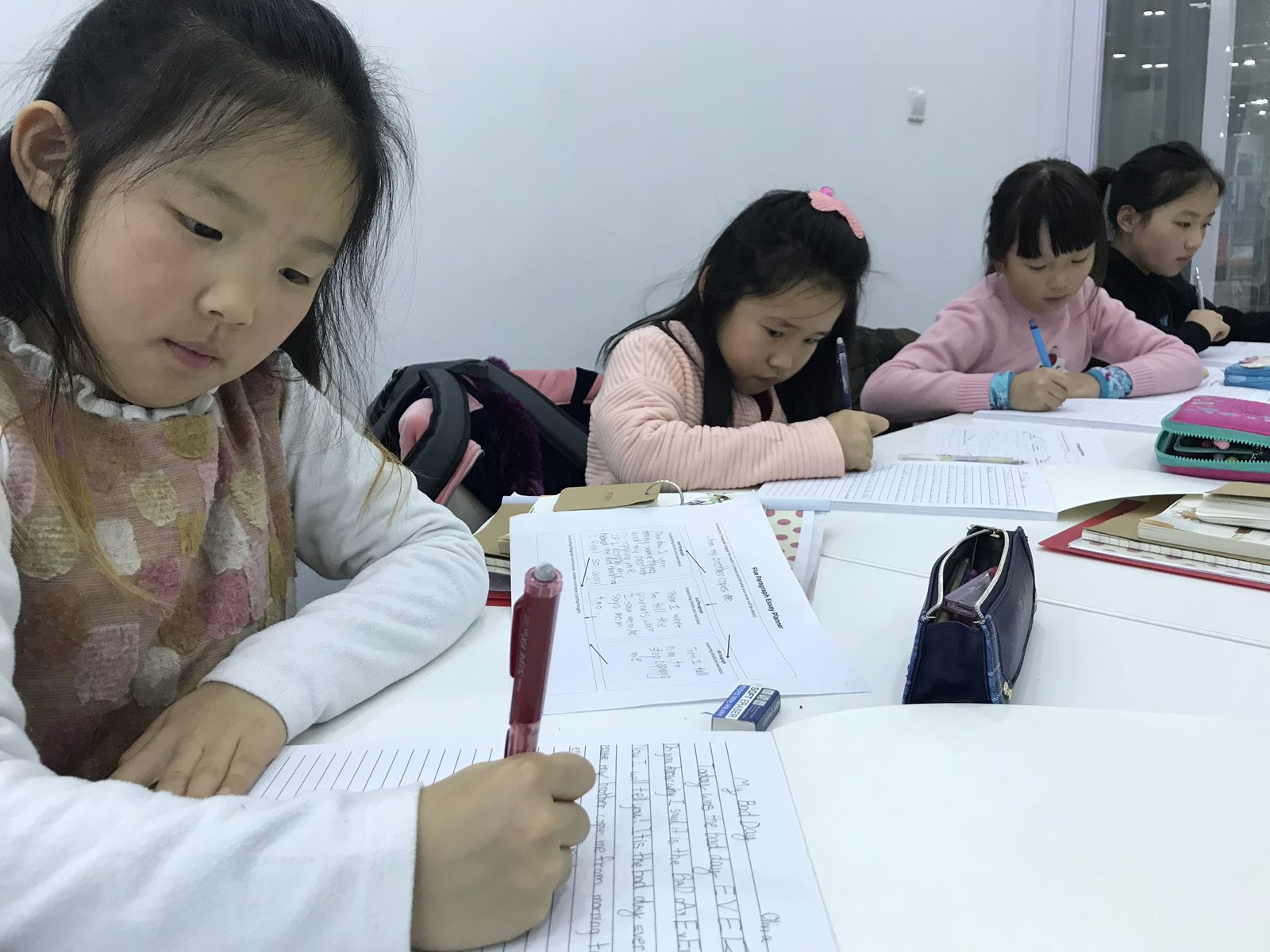 Students writing at the Studio Table